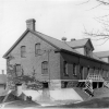 <p><strong>Colonial Revival</strong>: Early example of the style. Quartermaster Storehouse/Commissary (Building 16), built 1904, shown in view to northwest, ca. 1935.</p>
